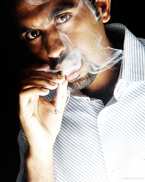 Portrait of male model Om Prakash Varma smoking cigarette
