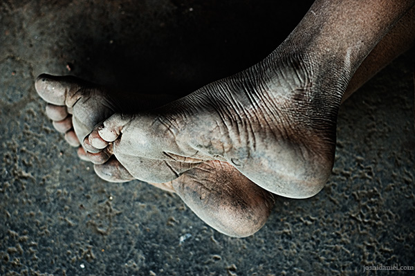 Feet of a young boy who was sleeping in the platform of Dadar railway station in Mumbai, India