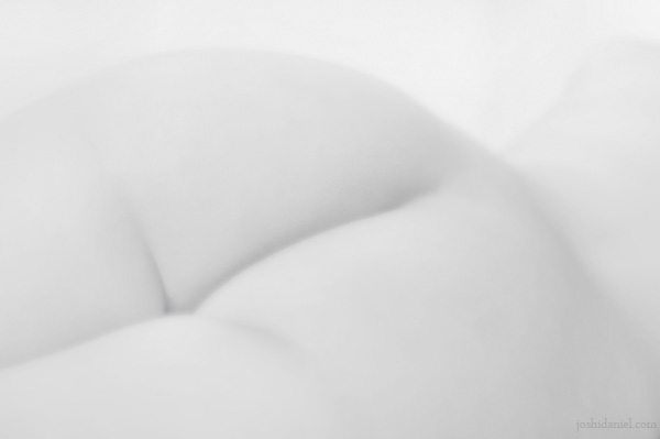 Black and white fine art nude of a girl lying down