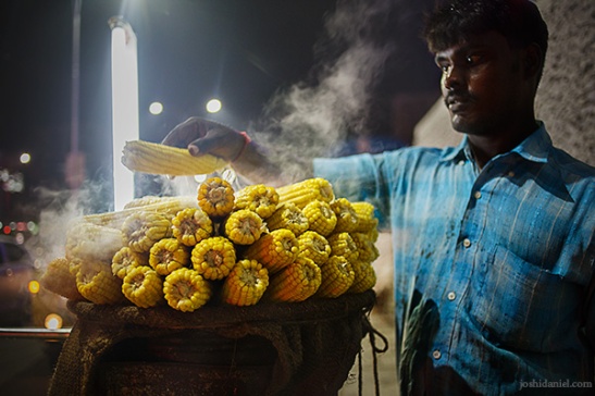 A man selling freshly steamed corn at Chennai, India