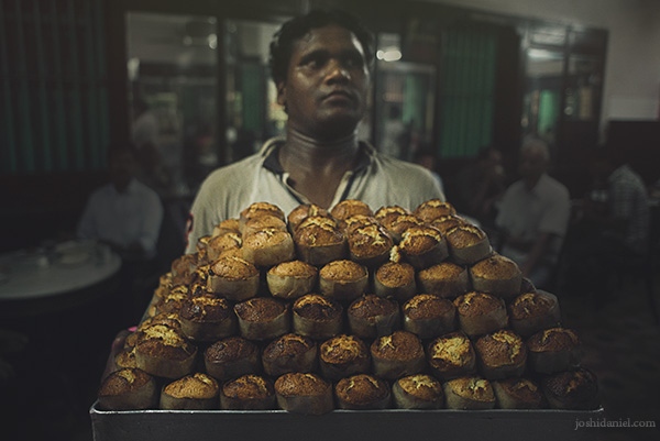 A worker at B. Merwan and Co. in Mumbai carrying a tray full of Mawa cake