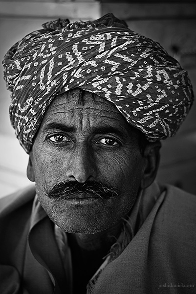 Black and white portrait of a turban-wearing Rajasthani man in Jaisalmer