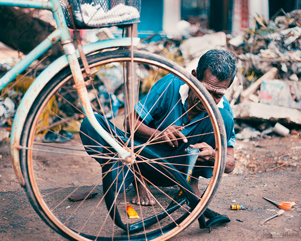 Bicycle repair on the road in Chennai, Tamil Nadu, India