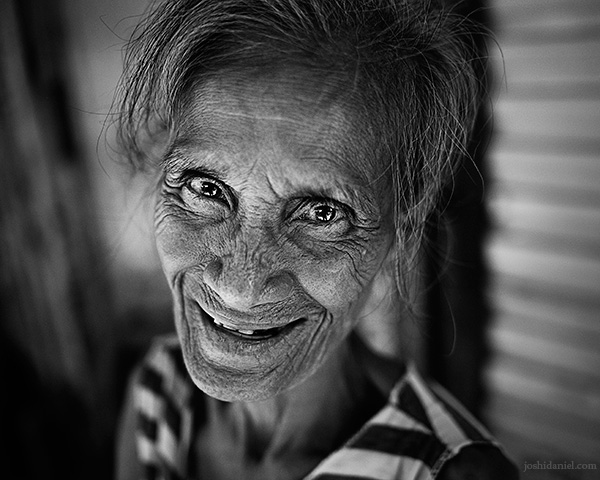 A 28mm wide angle black and white portrait of a cute street vendor in Binondo, the world's oldest Chinatown which is in Manila, Philippines