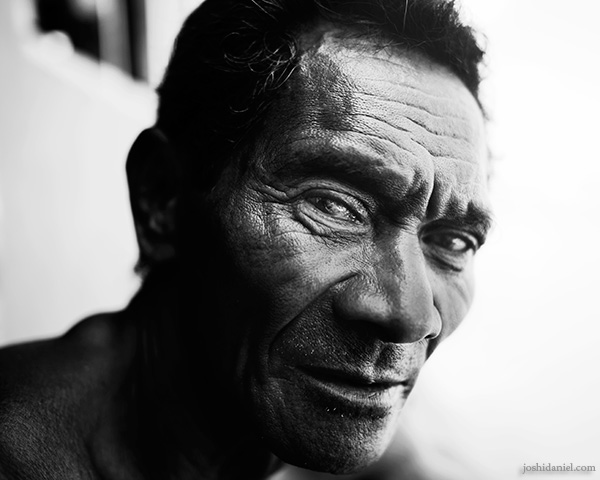 A 28mm wide angle black and white portrait of a man from Rainbow Village, Tual, Maluku, Indonesia