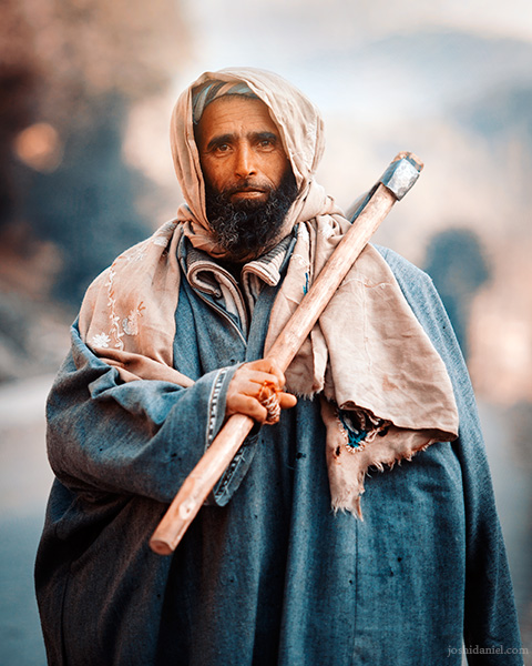 A Kashmiri man out at work and holding an axe in Anantnag, Jammu and Kashmir, India