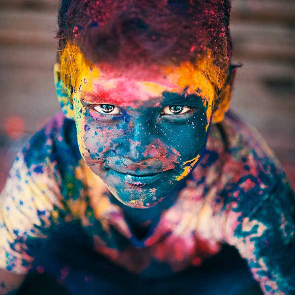A vibrant portrait of a boy during the festival of Holi in Sowcarpet, Chennai, Tamil Nadu, India