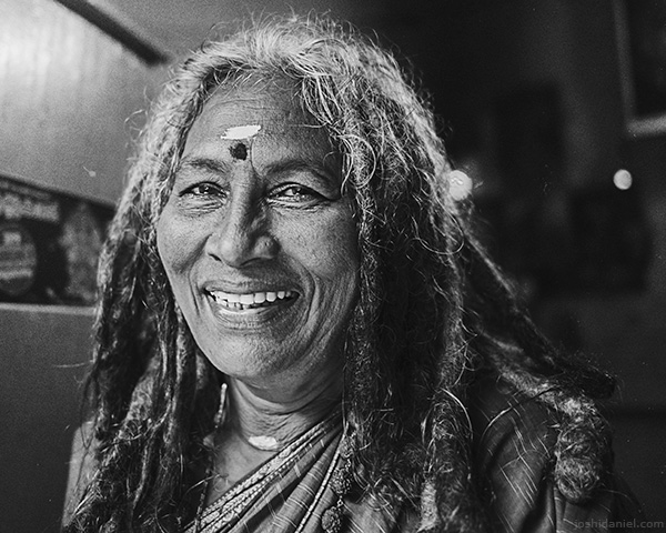 A 28mm wide angle black and white portrait of a woman with dreadlocks in Trivandrum, Kerala, India